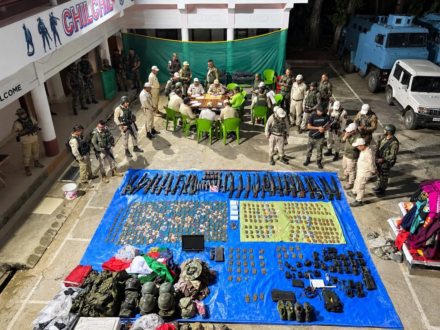 Security personnel with the seized arms and equipment after the raid at the Sinai SoO camp in Manipur.