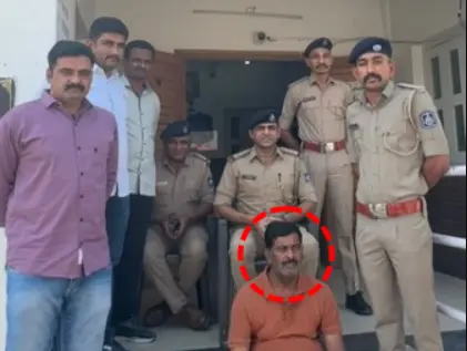 Abdul Sattar Mohammed Habib Qureshi (circled) with Rajula police personnel after his arrest.