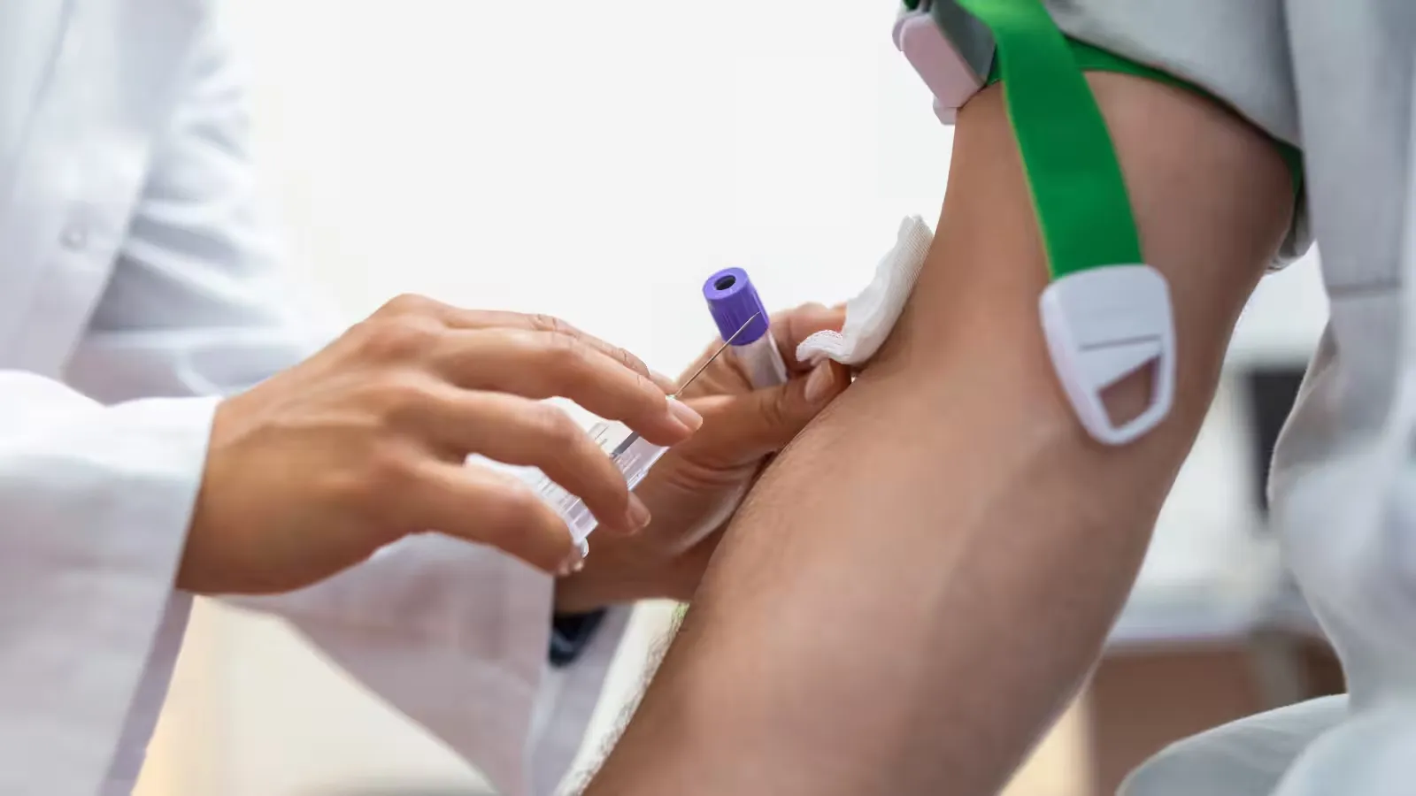 A blood sample being drawn from a patient's arm.